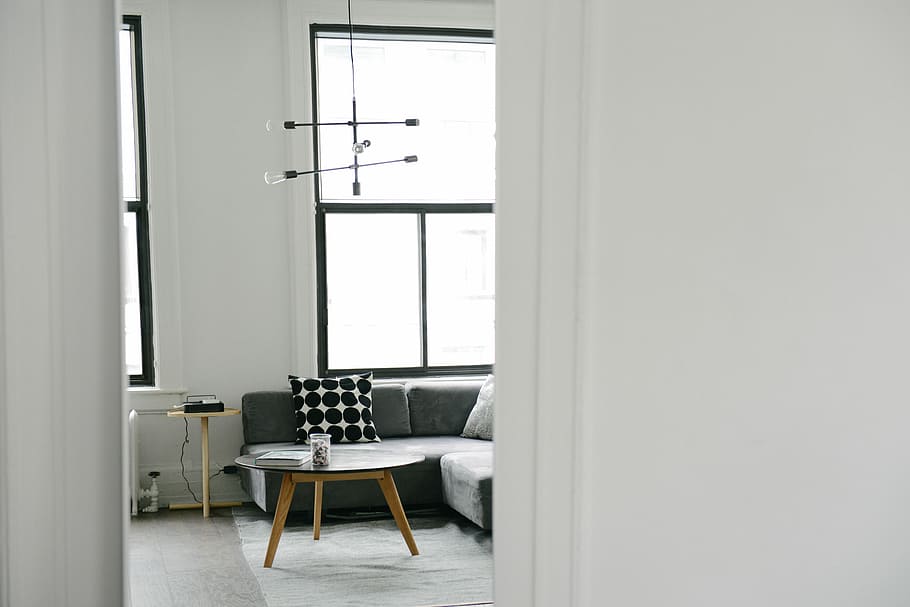 Cozy interior with a sofa, round brown table near sofa, office space HD wallpaper