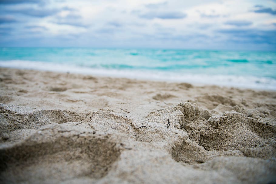 close up photography of footprints on shore, shallow focus photography of brown sand HD wallpaper