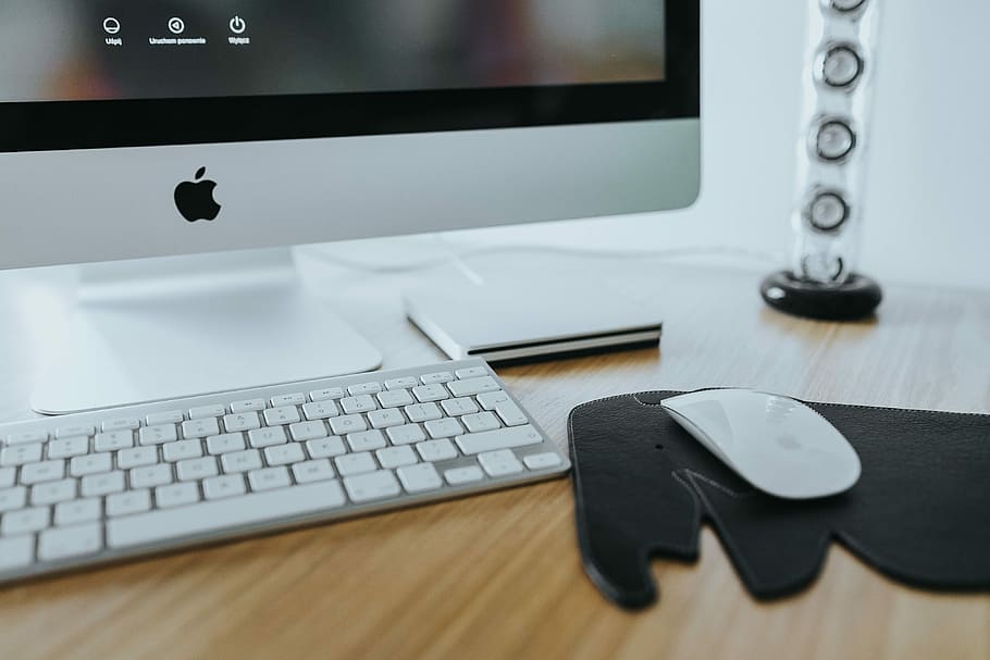 White Apple iMac computer with elephant mousepad, keyboard, monitor