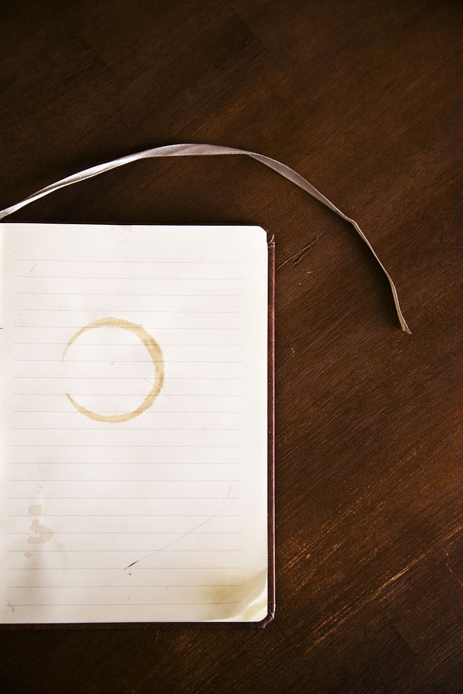 book and brown surface, white lined paper on brown wood plank HD wallpaper
