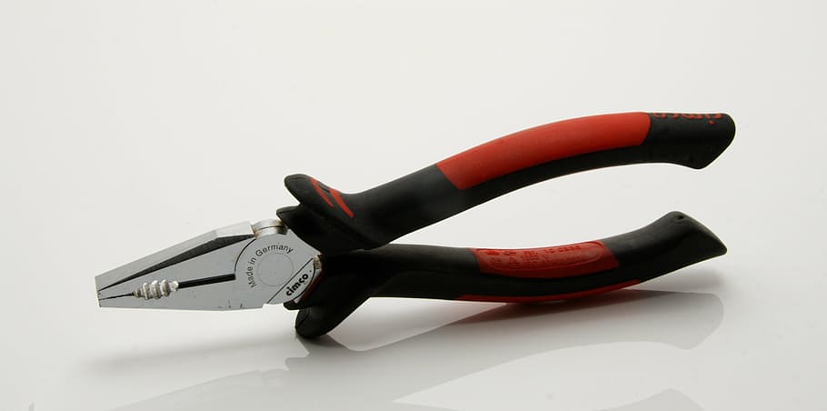 stainless steel pliers with red and black handle on white floor HD wallpaper