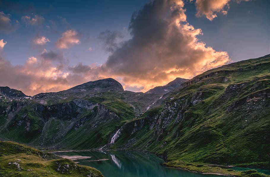 aerial view photography of river between mountain under commulus clouds, landscape photo of green grass covered mountain HD wallpaper