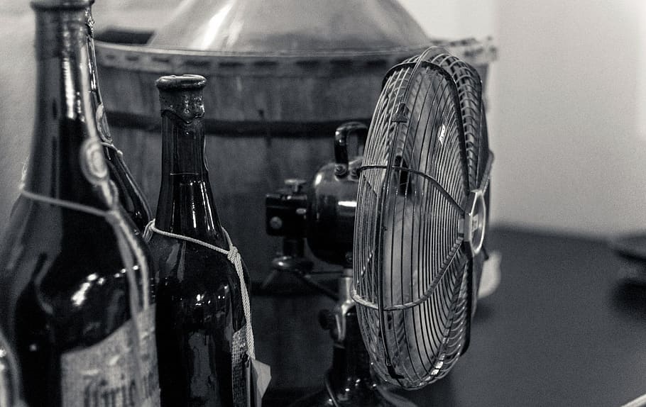 two black glass bottles beside desk fan, pub, bar, beer, indoors HD wallpaper