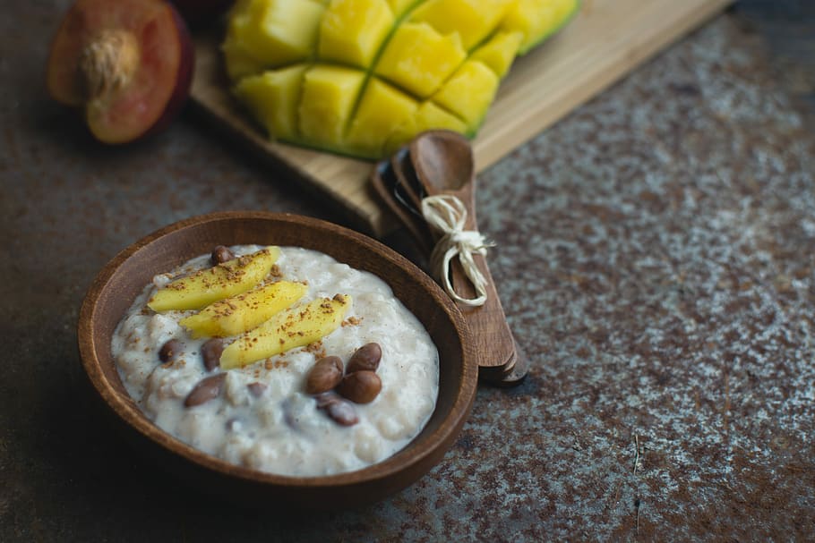 Exotic coconut rice and beans dessert with mango, cinnamon, close up HD wallpaper