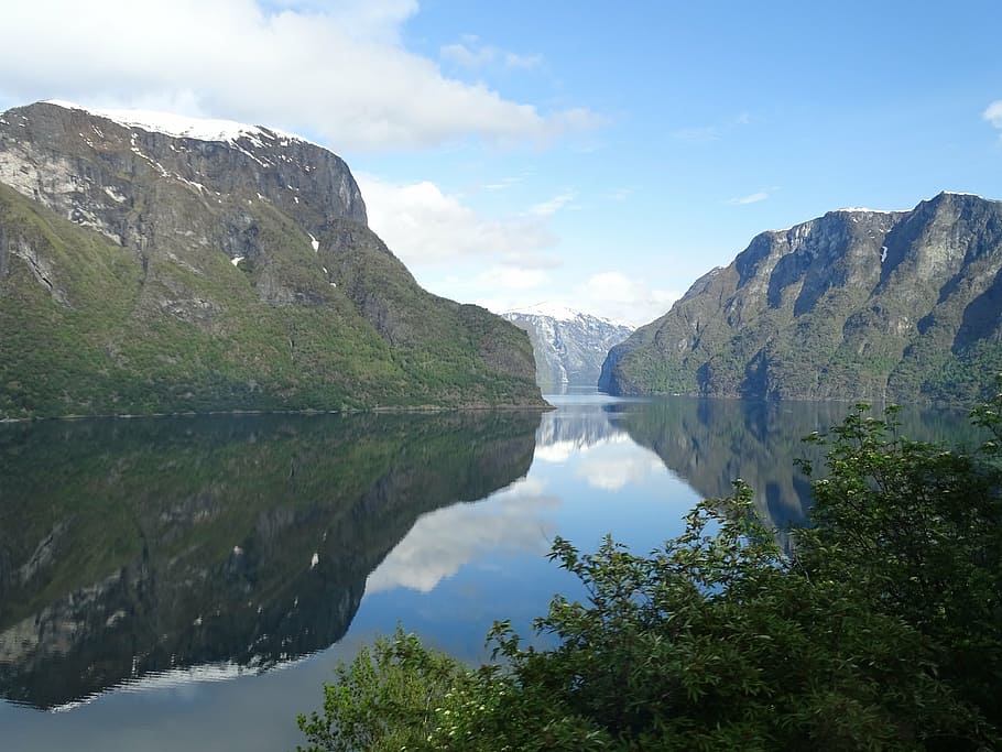 body of water between gray rock mountains at daytime, sognefjord