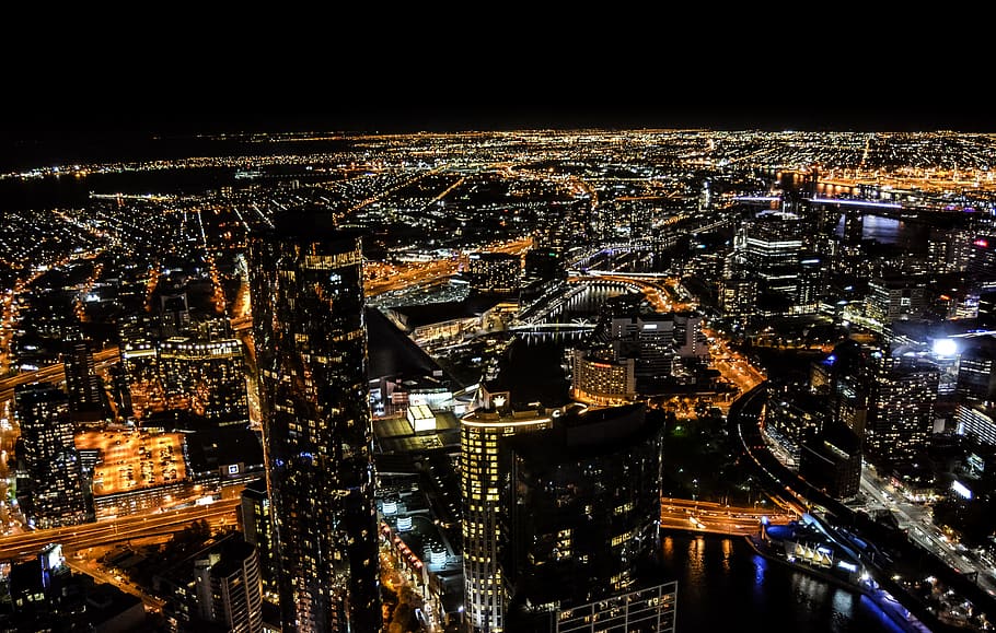 aerial photography of skyscraper at night time, high-angle photography of high-rise buildings HD wallpaper