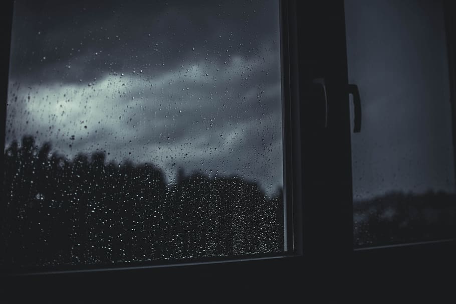 grayscale photography of glass-panel window during rainy day