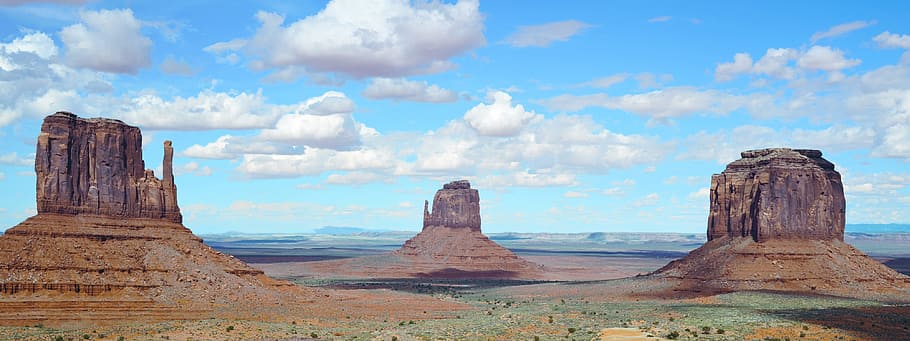 brown rock formations under cloudy blue sky during daytime, landscape