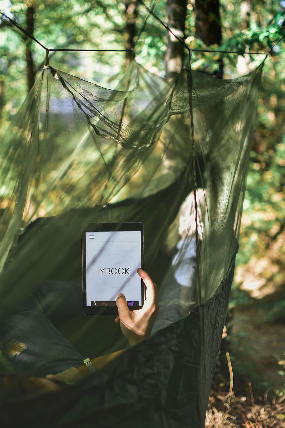 person in a hammock using Ybook tablet during daytime, person on hammock holding tablet computer HD wallpaper