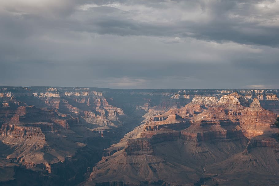 aerial view photography of mountains, grand canyon under cloudy sky HD wallpaper