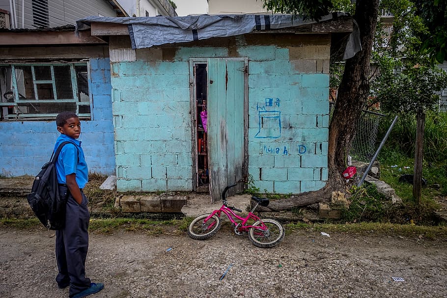 boy standing in front of door near bicycle, boy standing in front of blue concrete house HD wallpaper