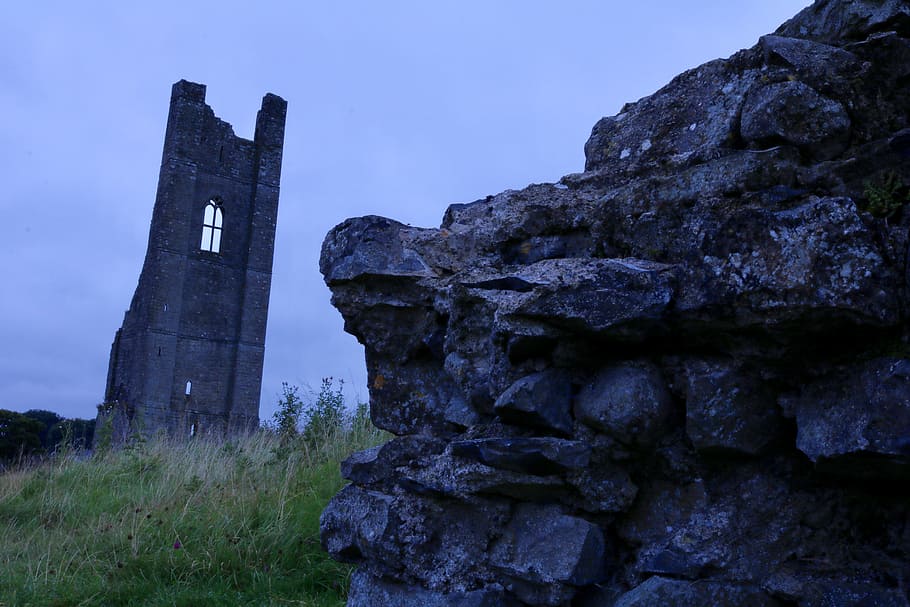 rock formation on green grass field, dark, tower, weird, darkness HD wallpaper