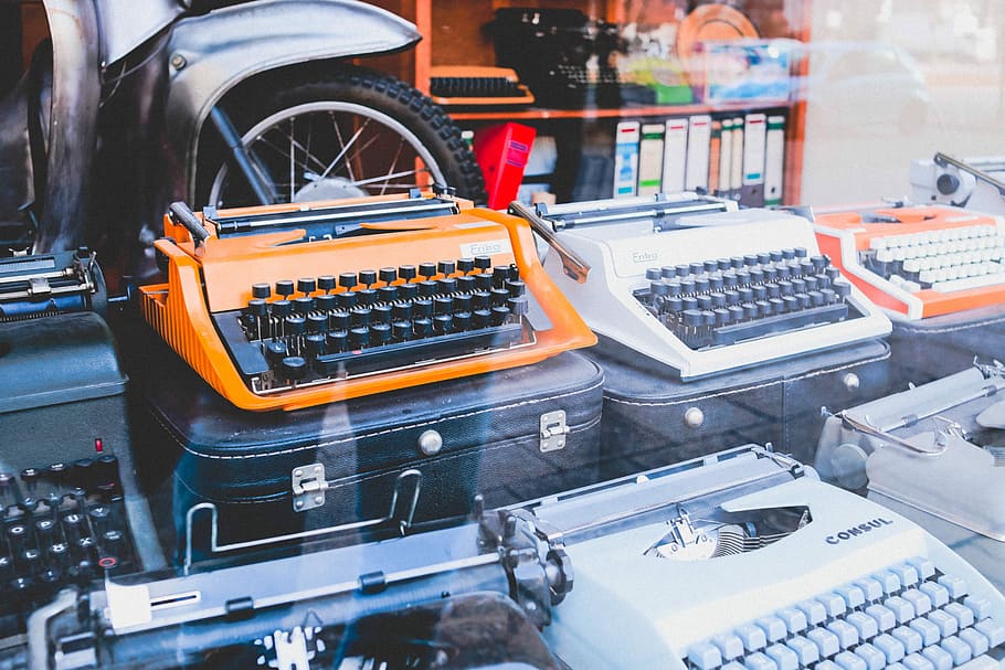 assorted colors of typewriters, white and orange typewriter machines on black cases, HD wallpaper