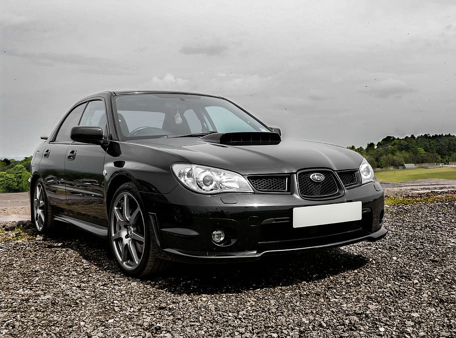 black Subaru Impreza parked on grey gravel under gray clouds, HD wallpaper