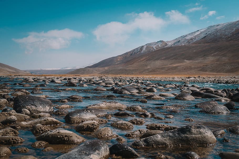 body of water with stones in front of mountain, river, current HD wallpaper