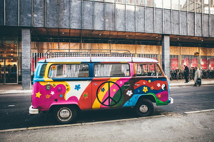 multicolored minivan parked on roadside near building, peace design bus passing by buildings, HD wallpaper