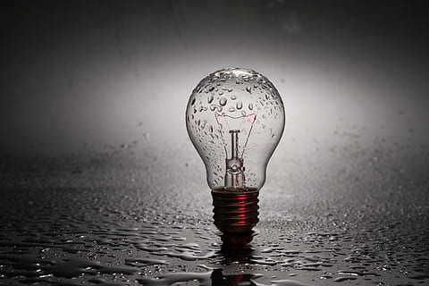 clear light bulb on gray surface with water droplets, energy HD wallpaper