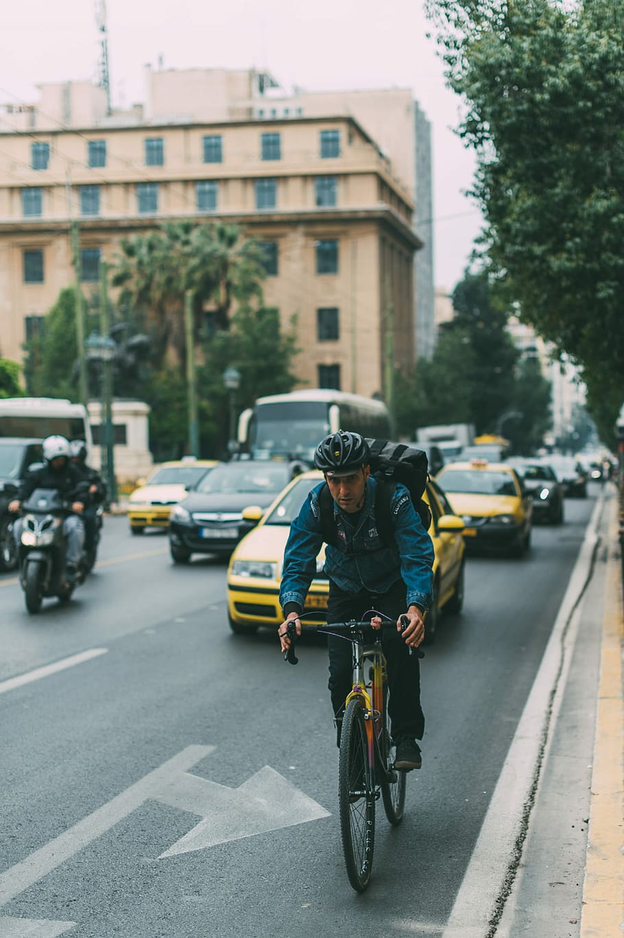 HD wallpaper: man riding bicycle on a road with cars during daytime ...