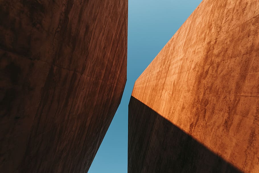 low angle photography of brown concrete building, photography of two pillars during daytime HD wallpaper