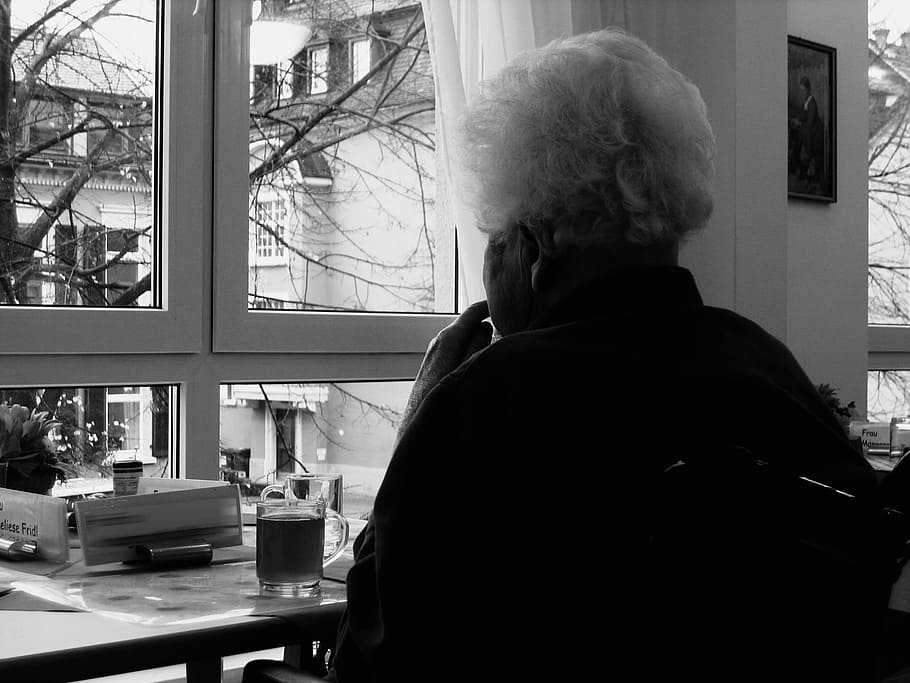 grayscale photo of person sitting near window, woman, old, dependent