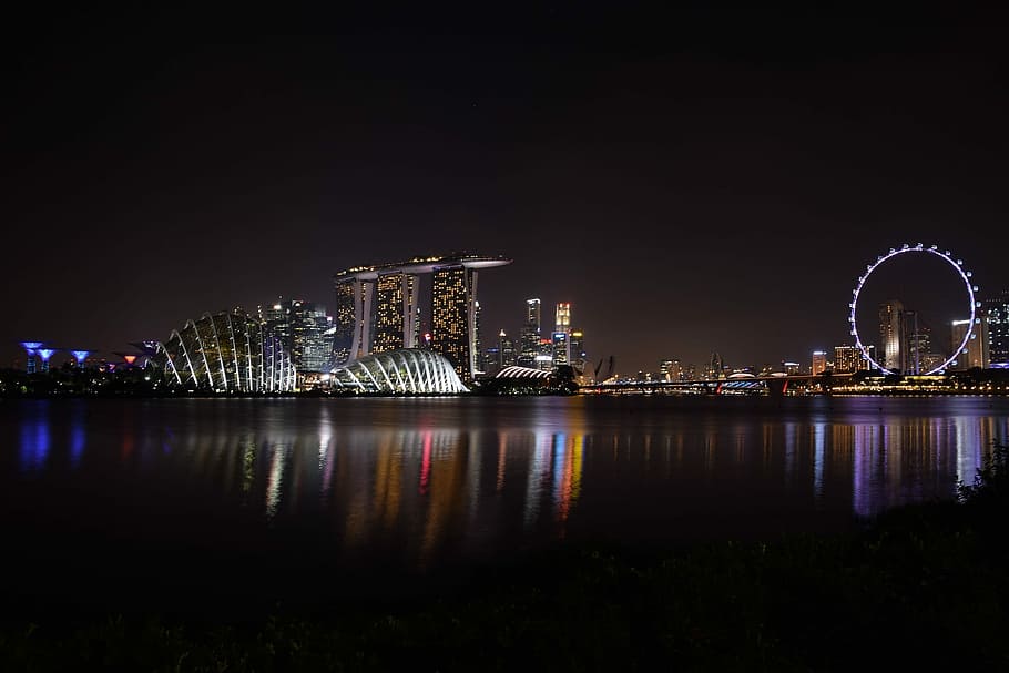 photography of city buildings during night time, reflection, illuminated HD wallpaper