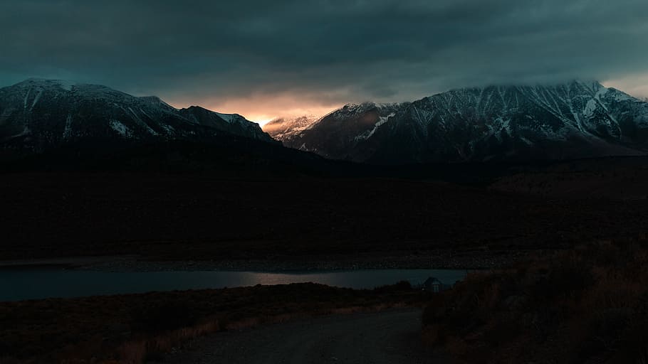 silhouette of mountains near body of water, terrain photography HD wallpaper