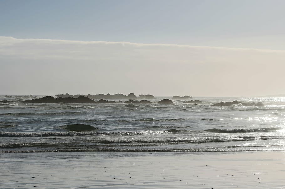beach, sea, back light, ocean, rock, water, wave, motion, sky HD wallpaper