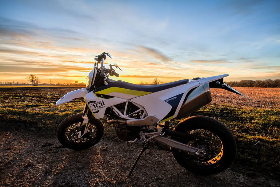 white Husqvarnia dirt bike parked near grass during, earth, motorcycle