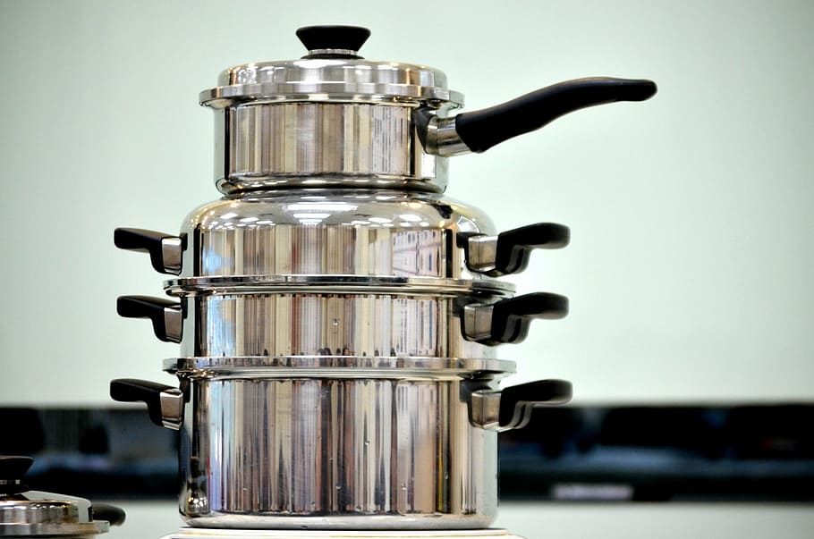 stack of four gray cooking pots with lid, pans, cookware, business