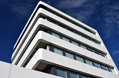 low-angle photography of white painted multi-storey building HD wallpaper