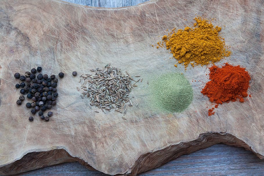 five assorted spices on wood slab, paprika, kaffir, powder, kumin
