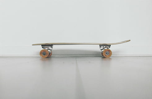 brown and black skateboard, cruiser, near, white, wall, still HD wallpaper