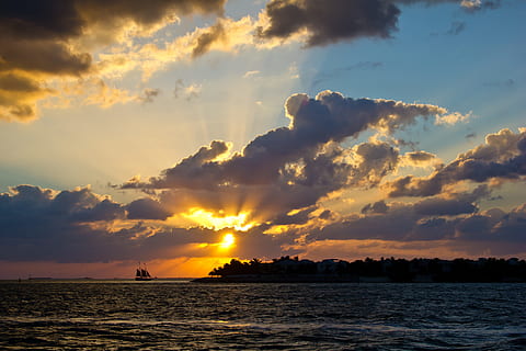 sunset over horizon with ship and island silhouettes, photo HD wallpaper