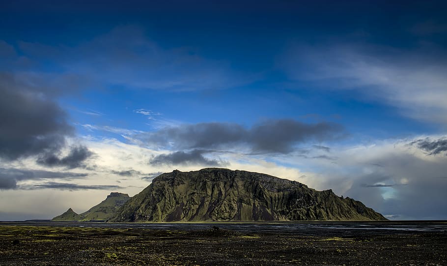 brown mountain near body of water at daytime, landscape photography of mountain under cloudy sky HD wallpaper