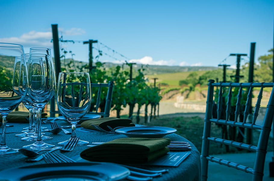 clear wine glasses beside plate on table, napa valley, vineyard