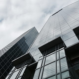 bottom view of high rise building under cloudy sky, perspective HD wallpaper