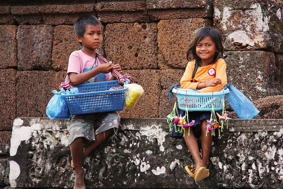 two boy and girl sitting on a concrete wall while carrying basket of goods, HD wallpaper
