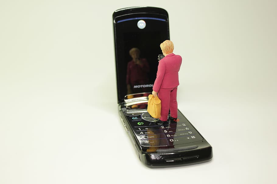 miniature figures, cellphone, mirror image, merkel figure, policy