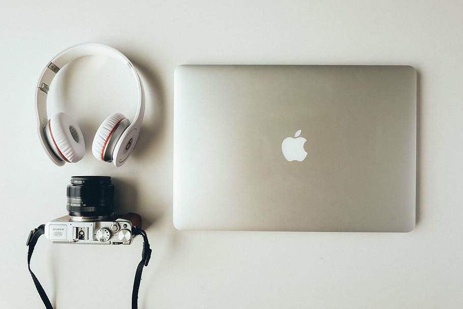silver MacBook; white Beats by Dr. Dre headphones; silver and black camera HD wallpaper