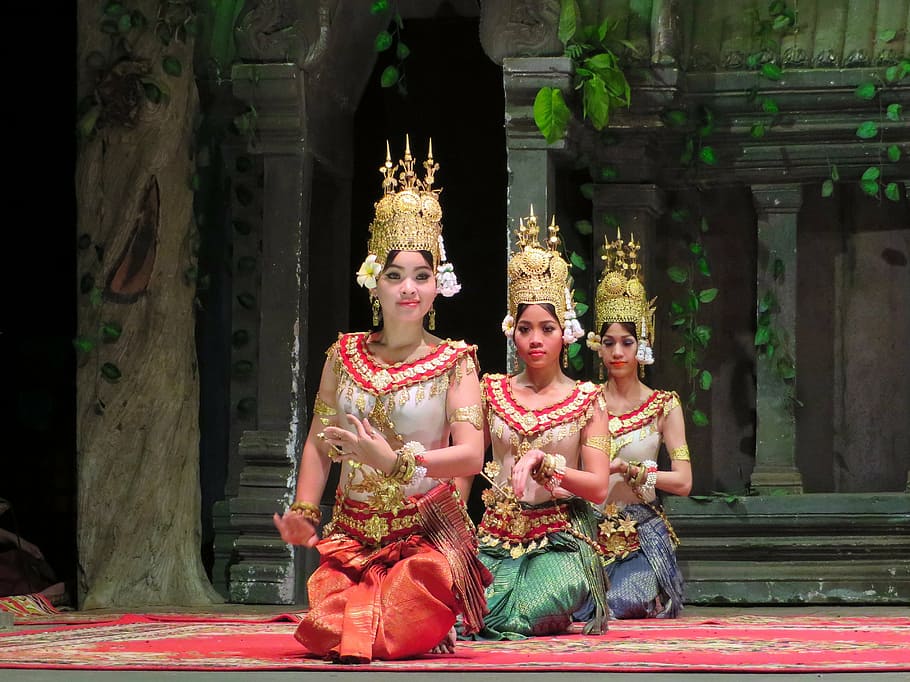 three kneeling women wearing traditional dresses, cambodia, dancers