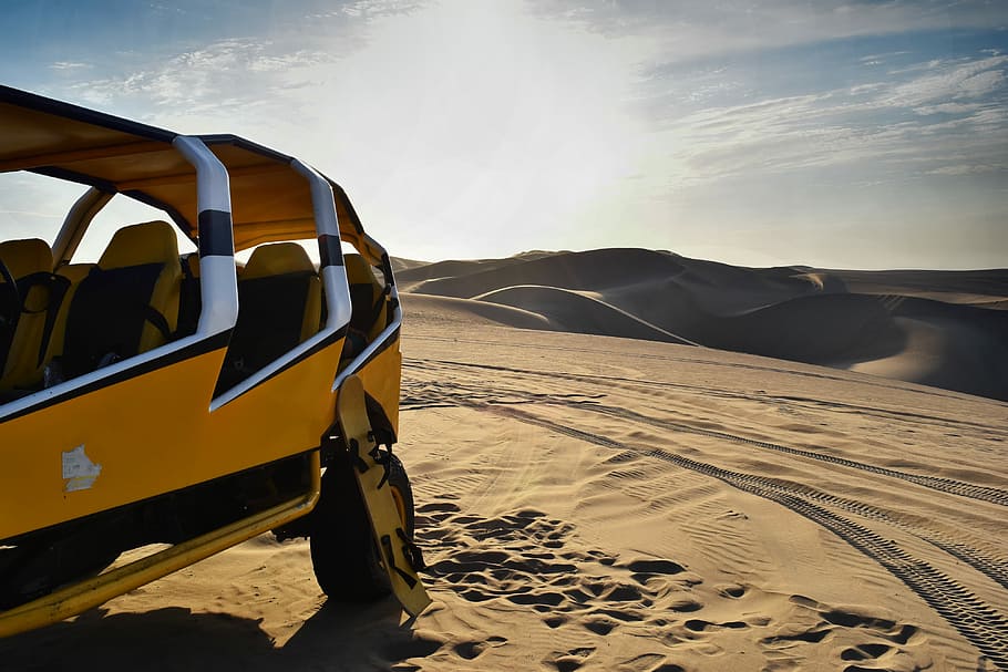 yellow and white UTV on desert, yellow car on desert, mountain