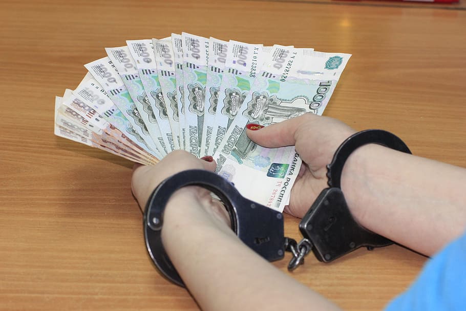 person holding fan of banknotes with hand cuffs, Handcuffs, Money