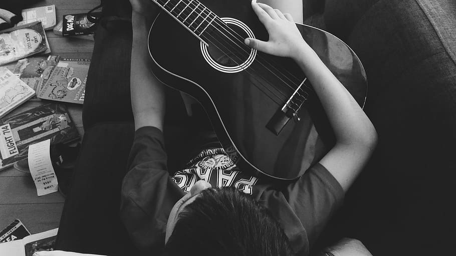Man Playing Guitar Lying on Couch in Grayscale Photography, acoustic