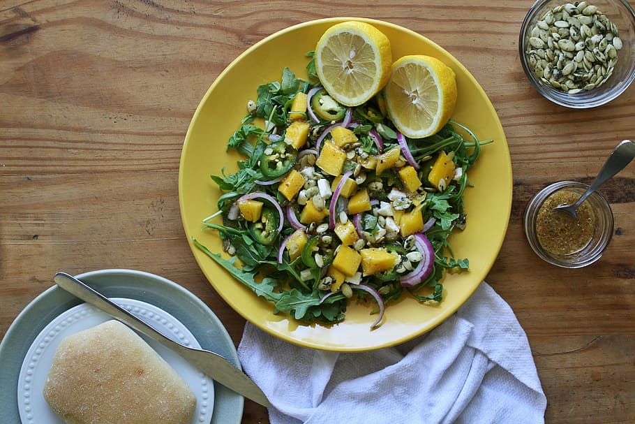 green salad on white ceramic plates, mango, lemons, bread, table HD wallpaper