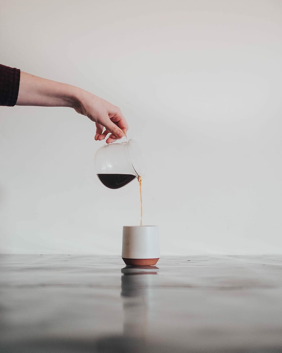 person pouring coffee in white mug, person pouring black liquid on white ceramic cup HD wallpaper
