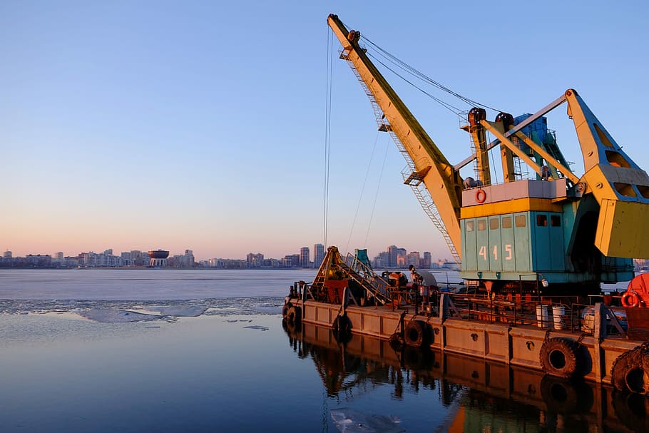 yellow and blue commercial machine near body of water, crane, equipment, dock, industry, industrial, heavy HD wallpaper