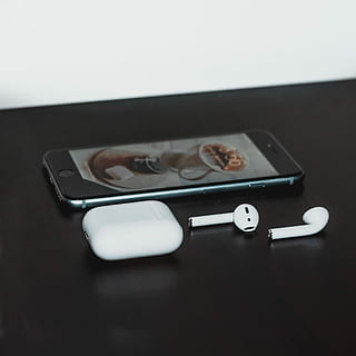 space gray iPhone 6 and Apple AirPods with case on black wooden table, space gray iPhone 6 and AirPods with charging case HD wallpaper