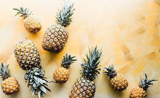 pineapples on brown surface, assorted pineapples photography during daytime HD wallpaper