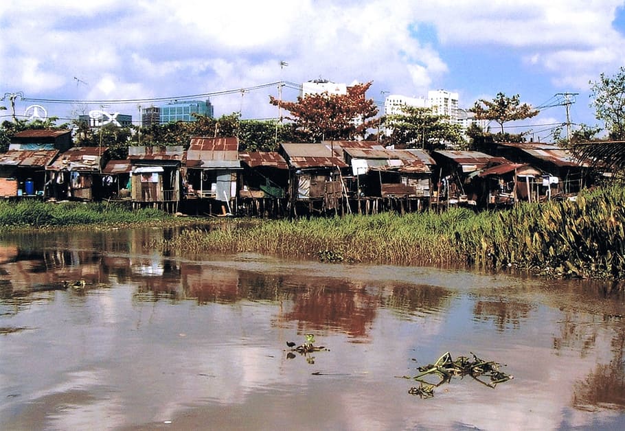 photography of brown house during daytime, saigon, slums, asia