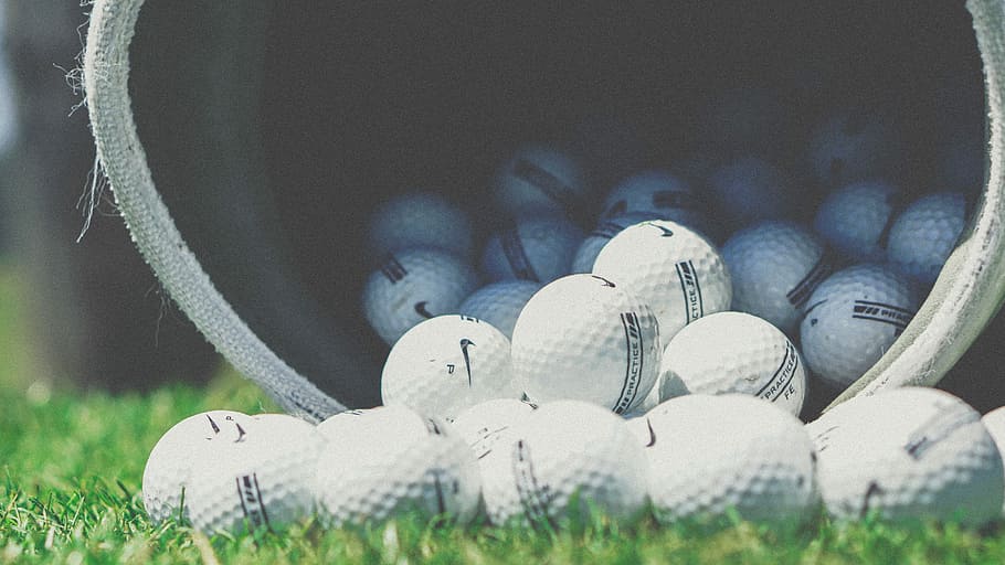 shallow focus photography of white golf balls, white Nike golf ball lot pouring out of bag, HD wallpaper